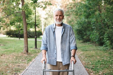 Photo of Senior man with walking frame in park