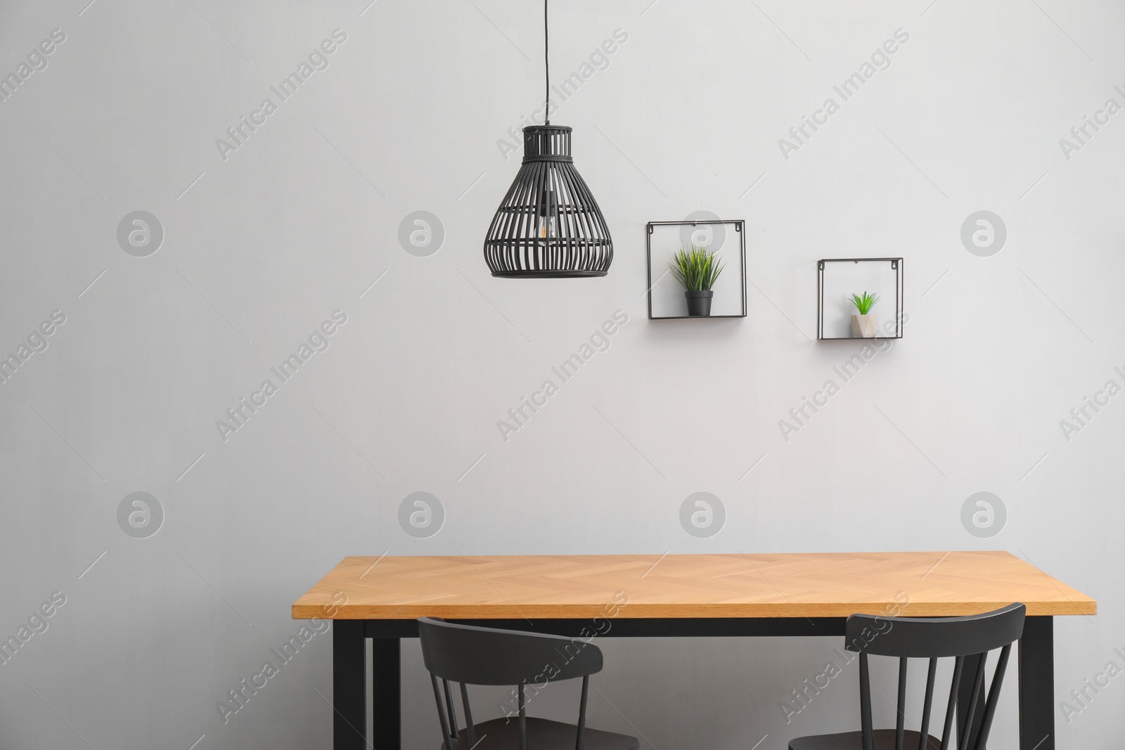 Photo of Wooden table with black chairs in stylish dining room