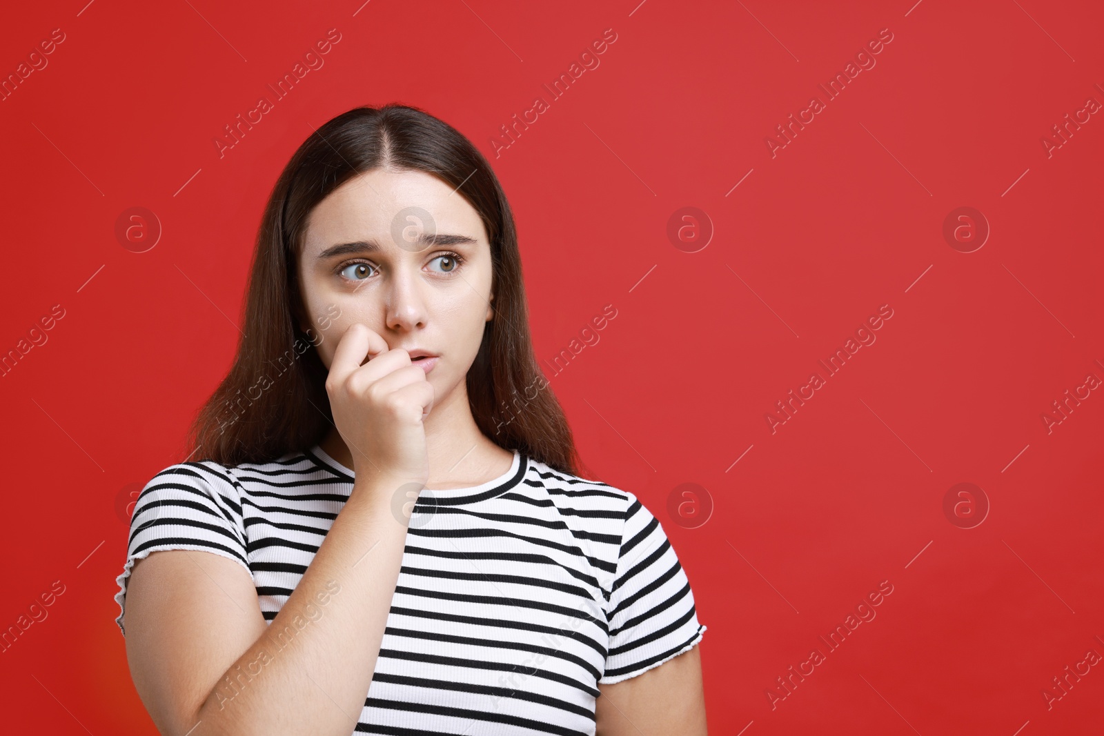 Photo of Stressful student before exam on red background, space for text