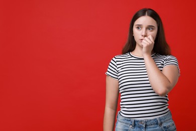 Photo of Stressful student before exam on red background, space for text