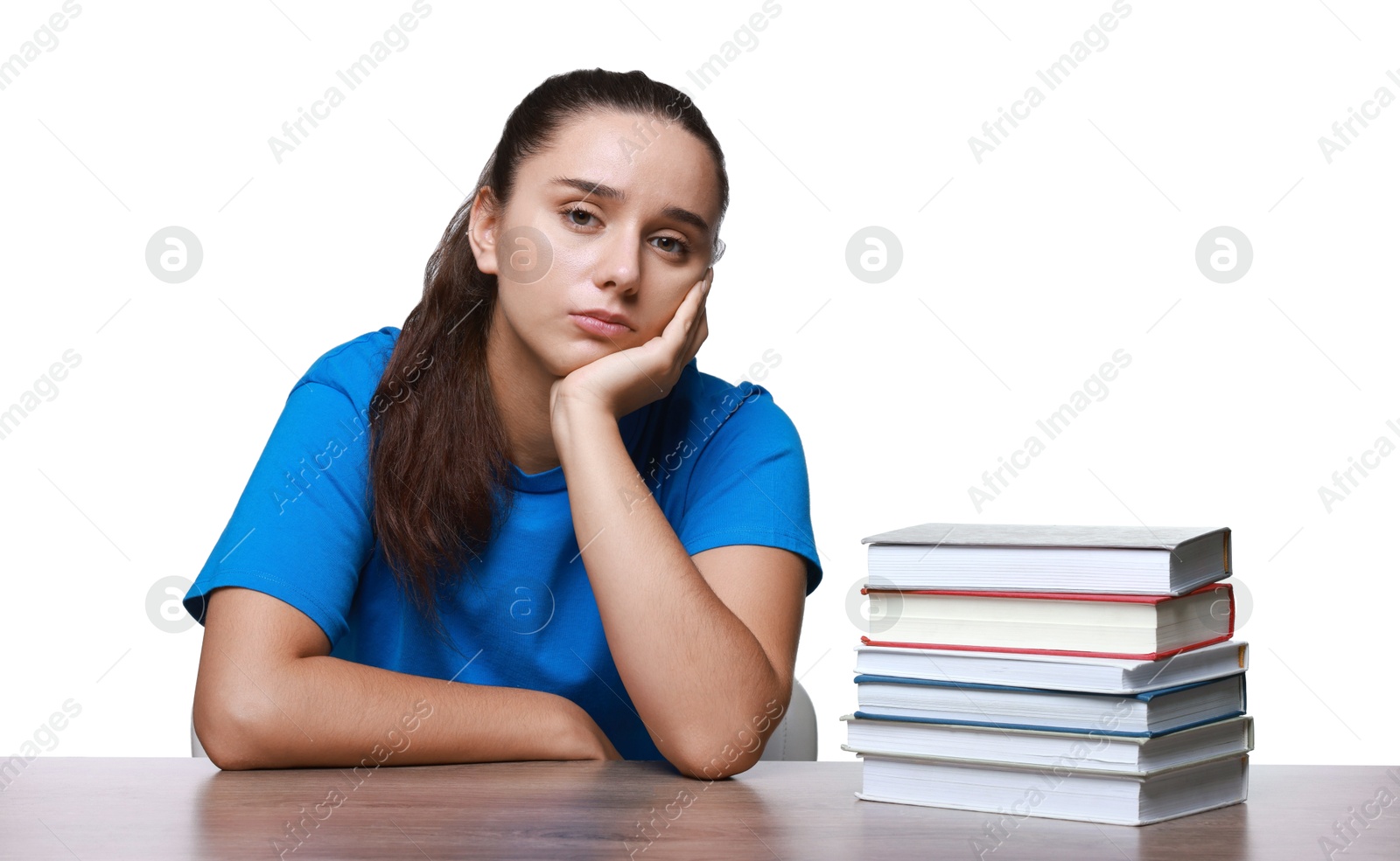 Photo of Young student with stack of books having stress before exam at wooden table isolated on white