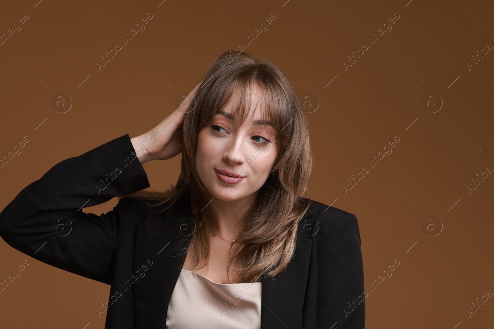 Photo of Attractive woman with stylish haircut on brown background