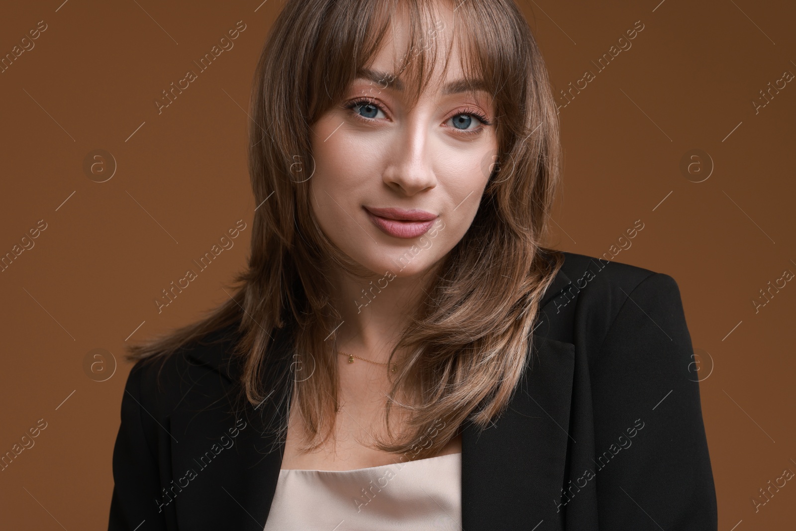 Photo of Attractive woman with stylish haircut on brown background