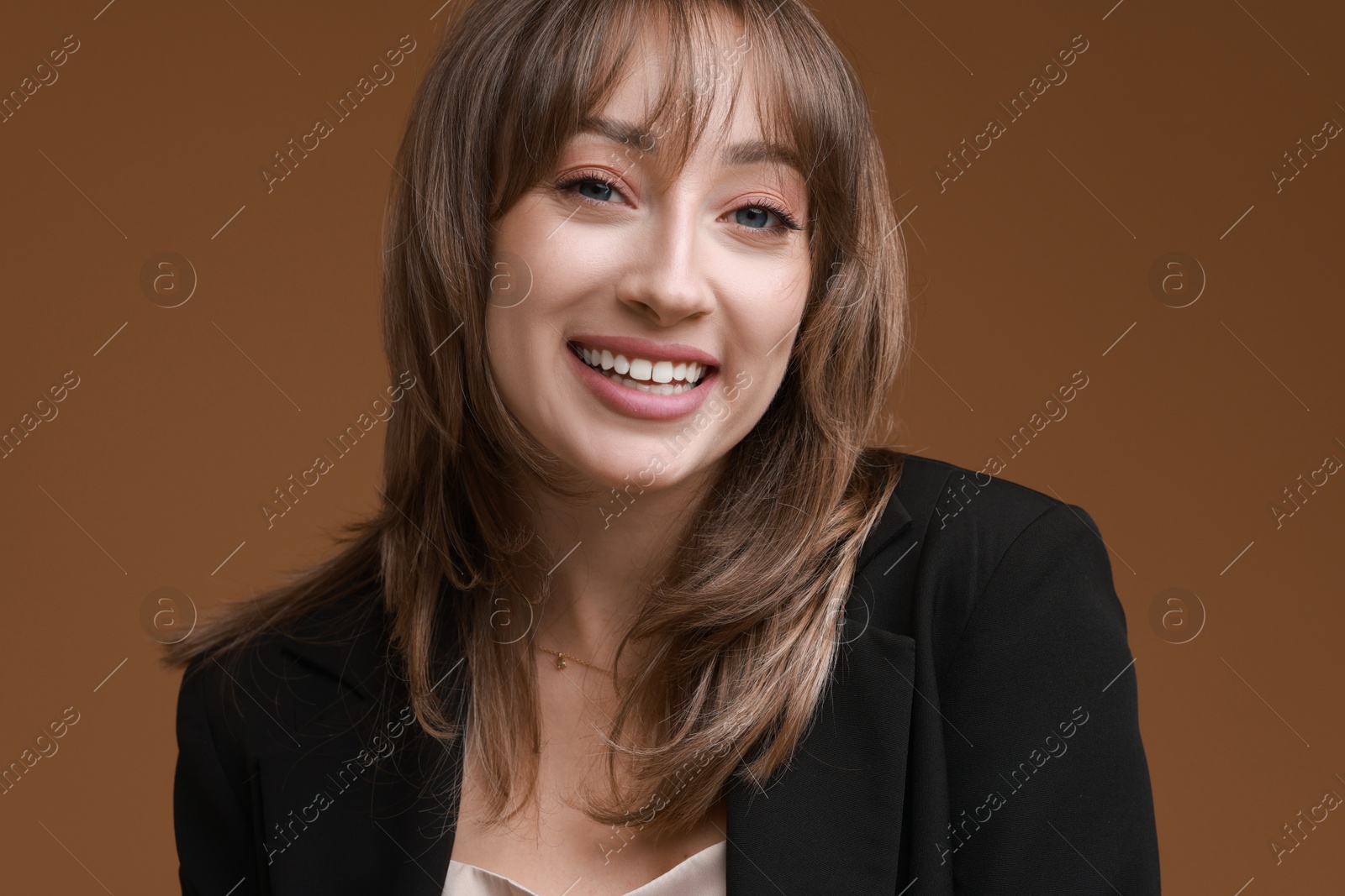 Photo of Attractive woman with stylish haircut on brown background