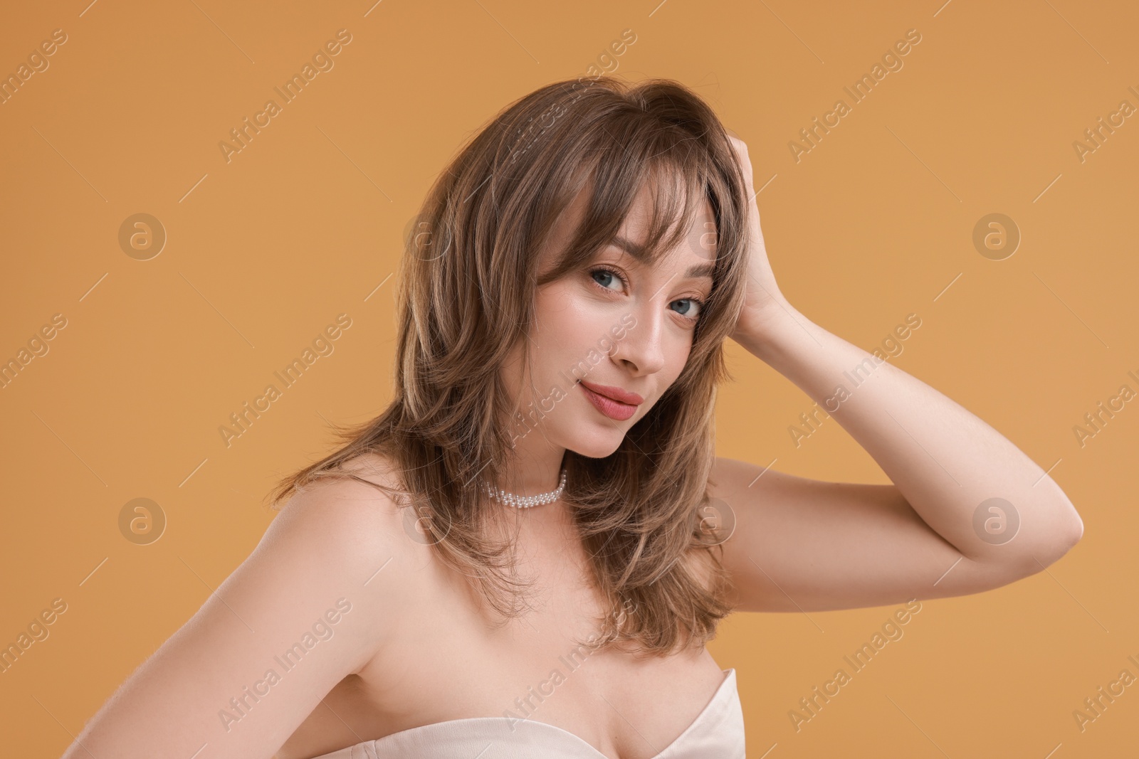 Photo of Attractive woman with stylish haircut on beige background