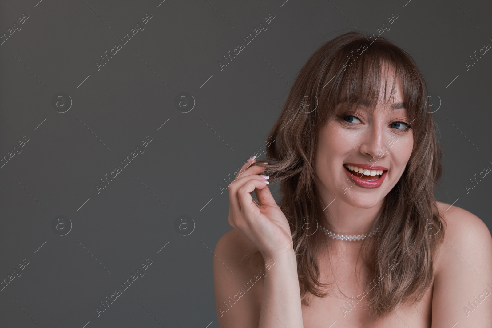 Photo of Attractive woman with stylish haircut on grey background, space for text