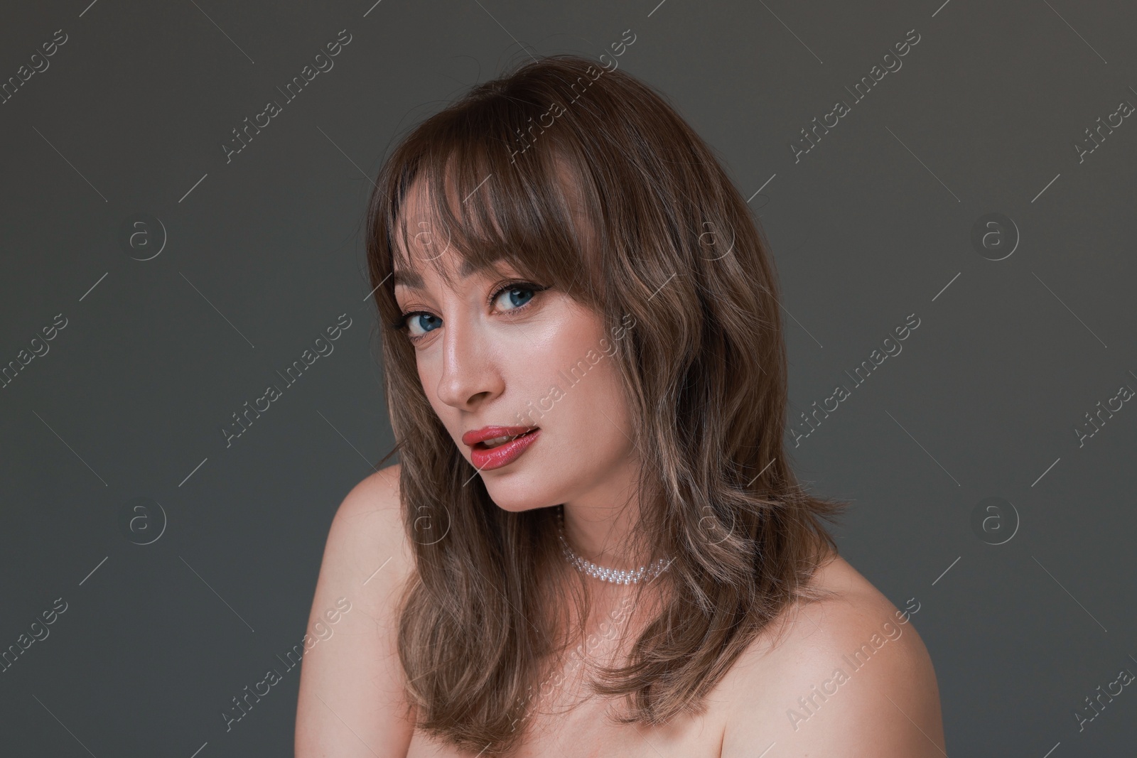 Photo of Attractive woman with stylish haircut on grey background