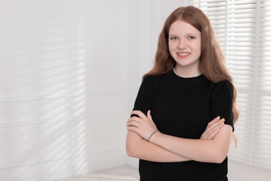 Photo of Portrait of happy teenage girl at home, space for text