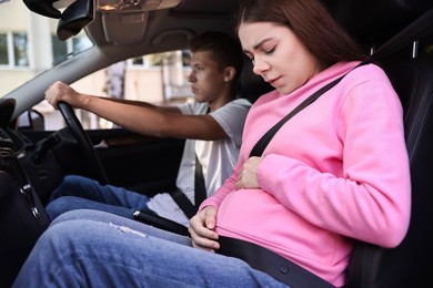 Photo of Pregnant woman travelling with her husband by car