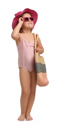 Photo of Cute little girl in swimsuit with hat and bag on white background