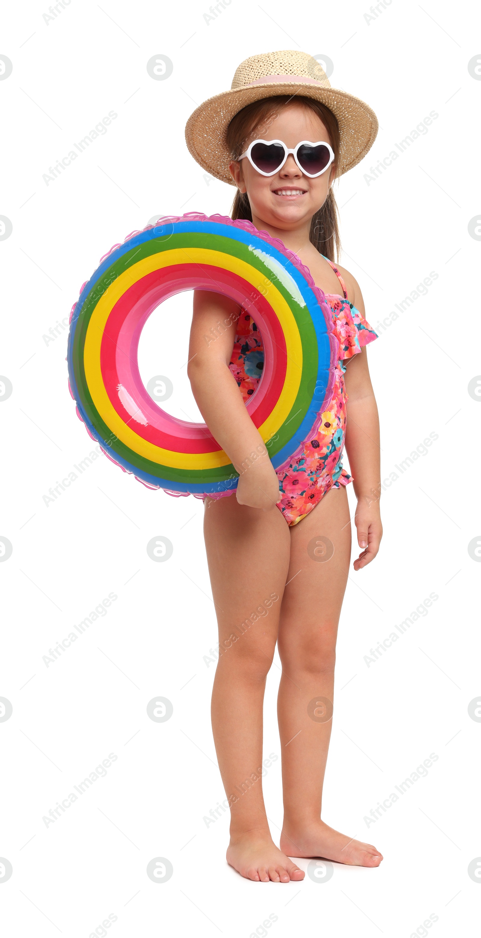 Photo of Cute little girl in swimsuit with straw hat and inflatable ring on white background