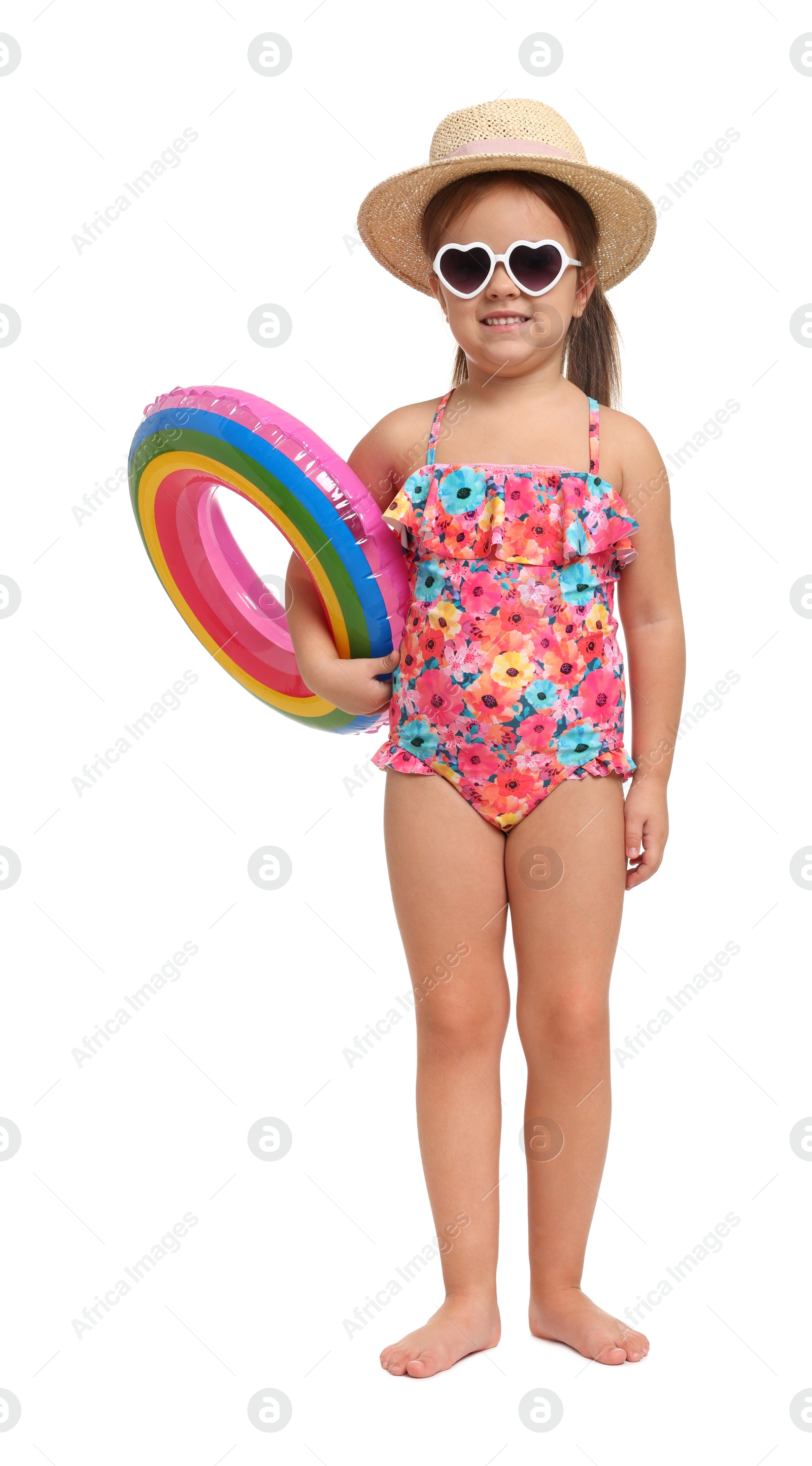 Photo of Cute little girl in swimsuit with straw hat and inflatable ring on white background