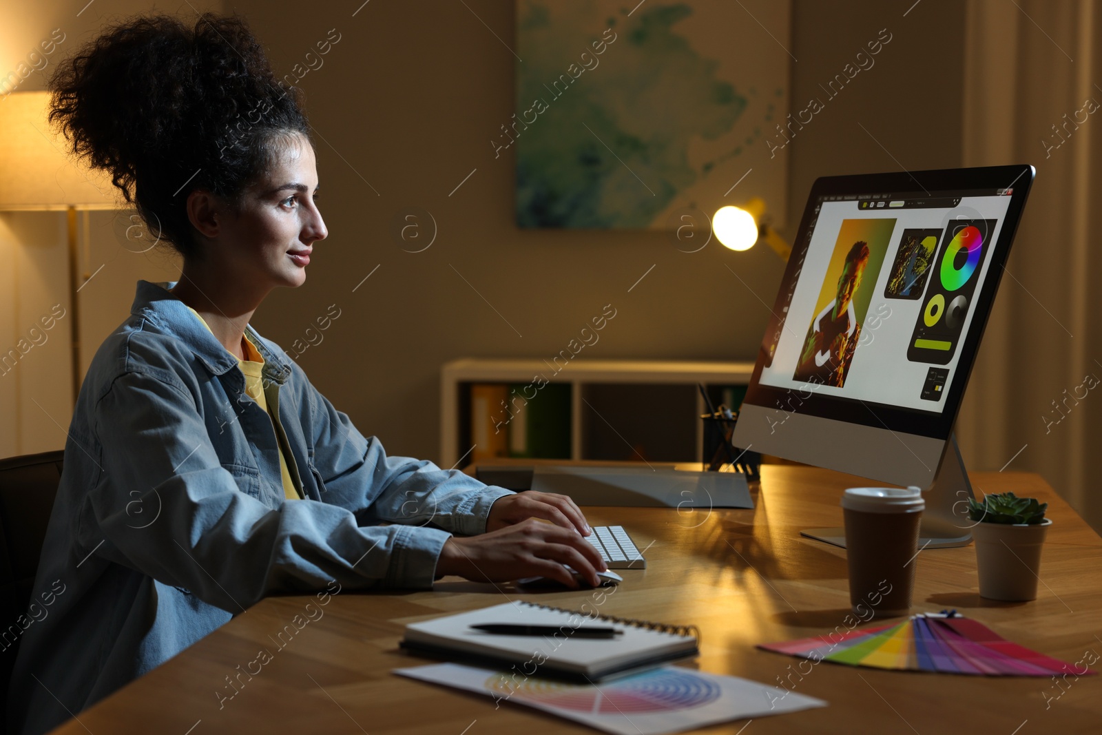 Photo of Designer working on computer indoors at night