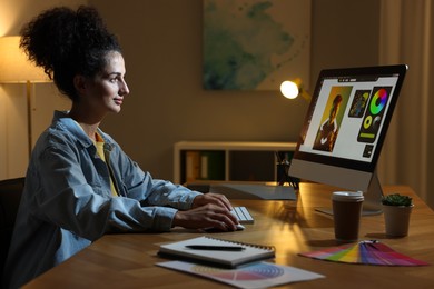 Photo of Designer working on computer indoors at night