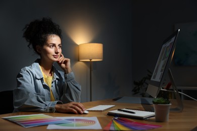 Photo of Designer working on computer indoors at night