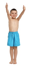 Photo of Cute little boy in beachwear showing thumbs up on white background