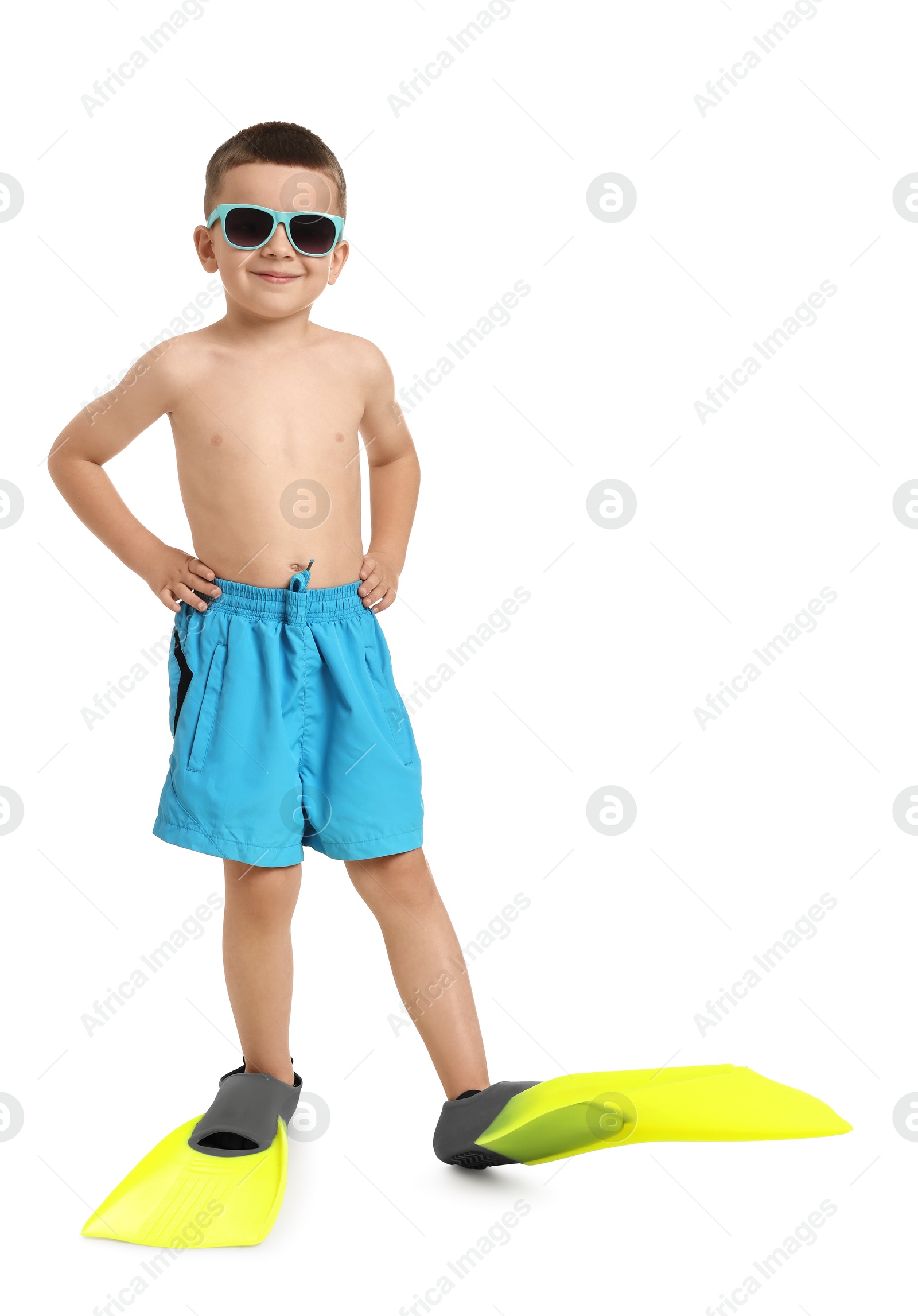 Photo of Cute little boy in beachwear with sunglasses and fins on white background