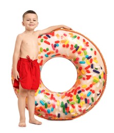 Photo of Cute little boy in beachwear with inflatable ring on white background