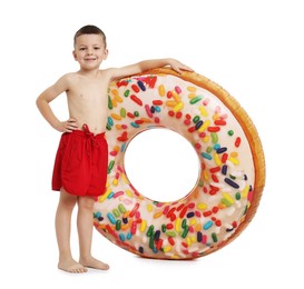 Photo of Cute little boy in beachwear with inflatable ring on white background