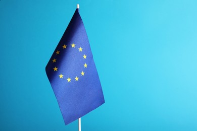 Photo of One flag of European Union on light blue background. Space for text