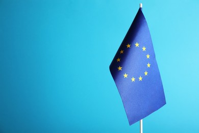 Photo of One flag of European Union on light blue background. Space for text