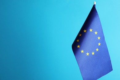 Photo of One flag of European Union on light blue background. Space for text