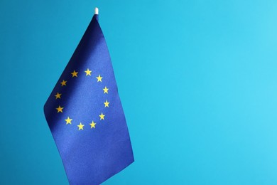 Photo of One flag of European Union on light blue background. Space for text