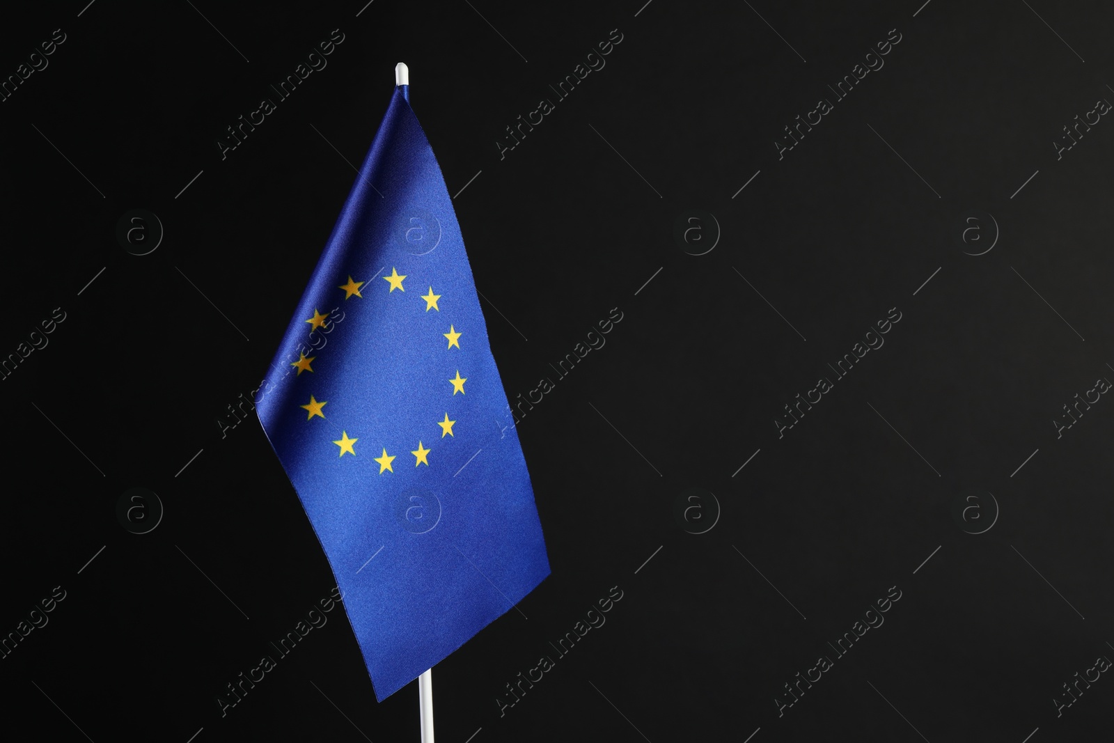 Photo of One flag of European Union on black background. Space for text