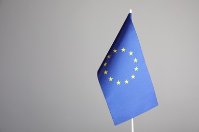 Photo of One flag of European Union on grey background. Space for text