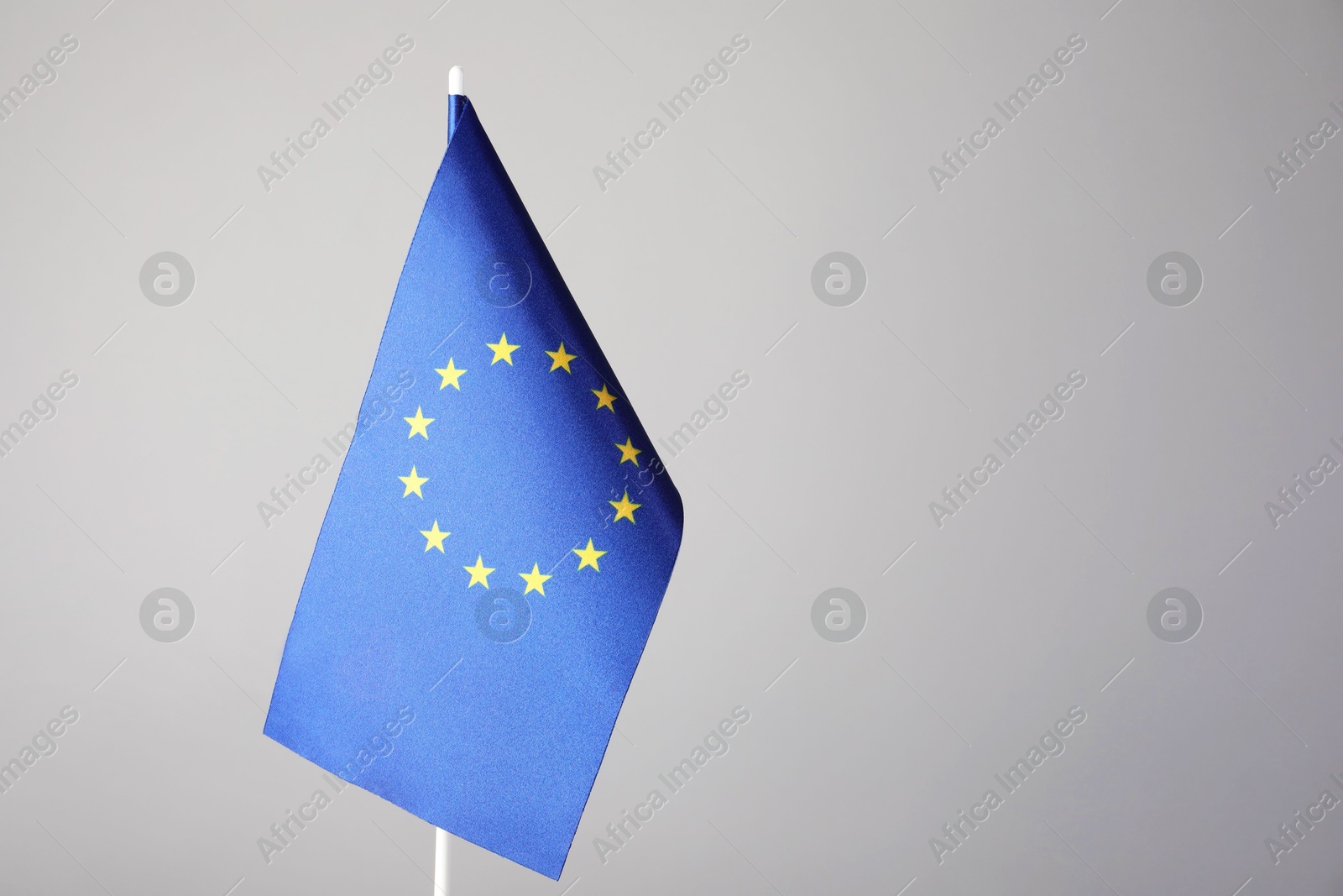 Photo of One flag of European Union on grey background. Space for text