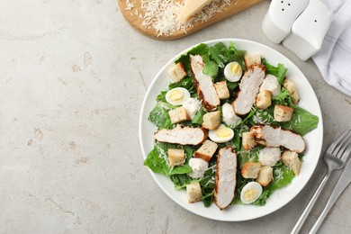 Photo of Tasty Caesar salad with chicken on light grey table, flat lay. Space for text