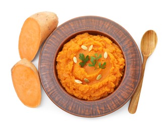 Photo of Tasty mashed sweet potato with pumpkin seeds in bowl, spoon and cut vegetable isolated on white, top view