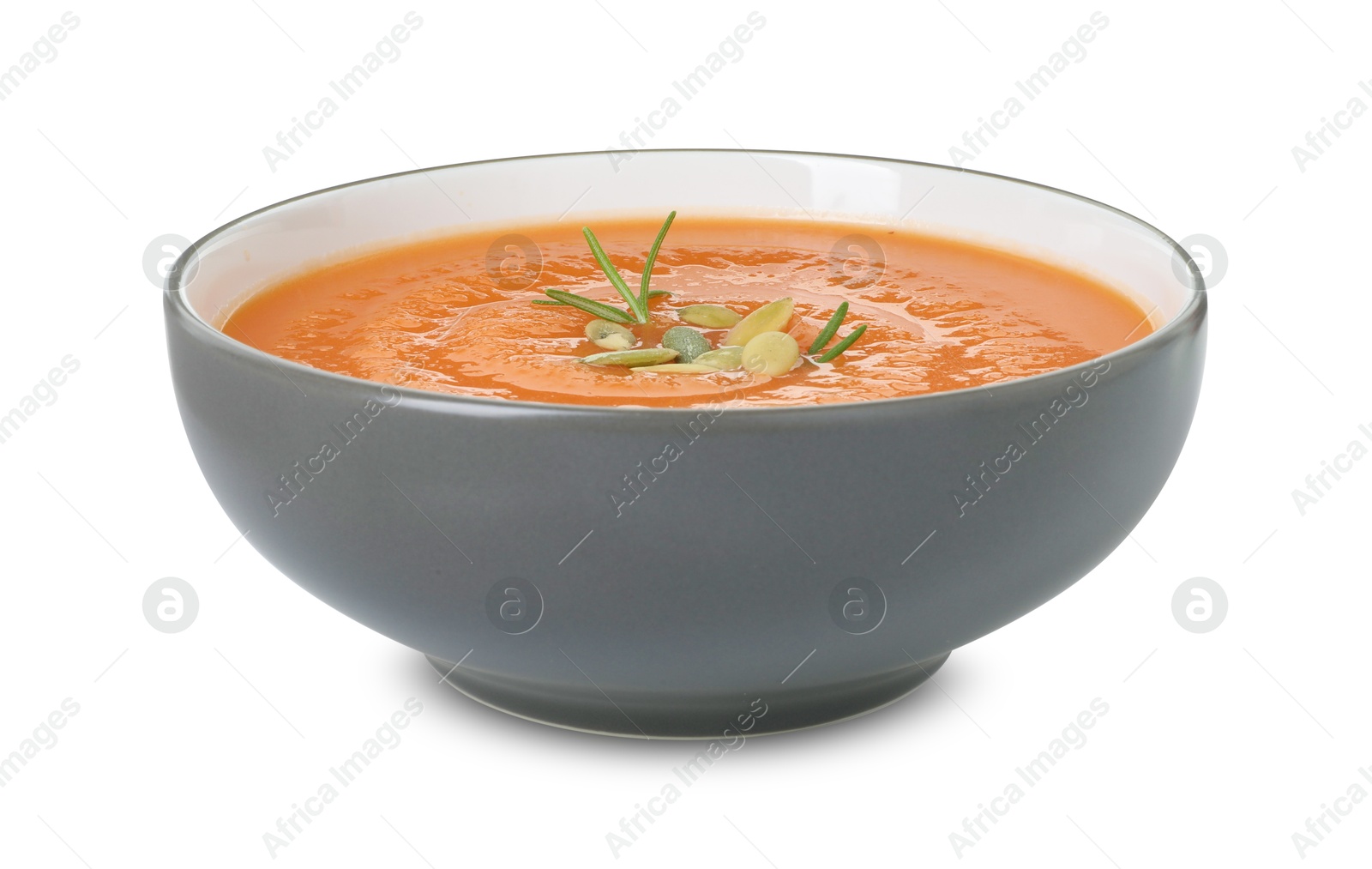 Photo of Delicious sweet potato soup with pumpkin seeds in bowl isolated on white