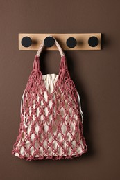 Photo of Handmade macrame shopping bag on brown wall