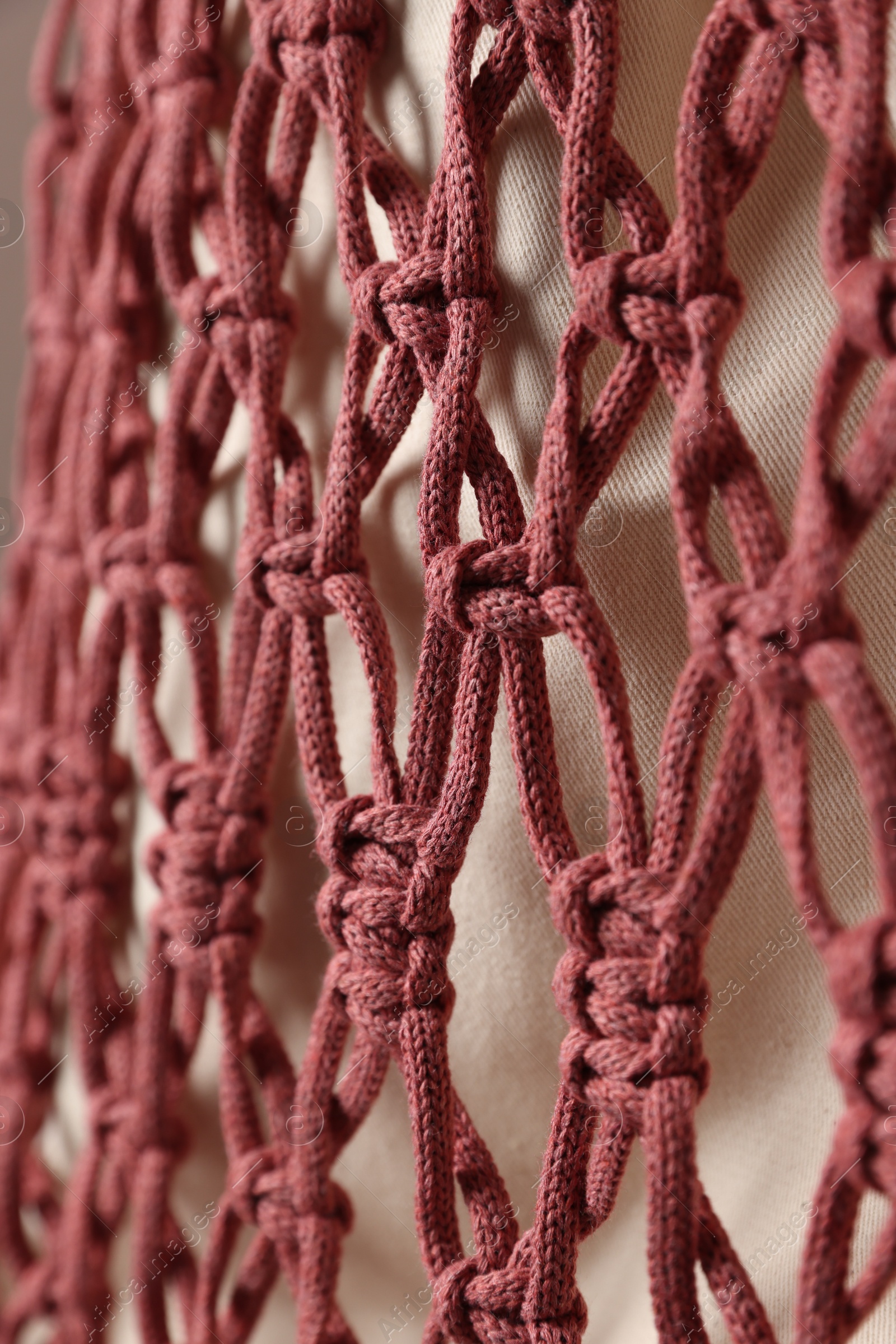 Photo of Handmade macrame shopping bag on white background, closeup