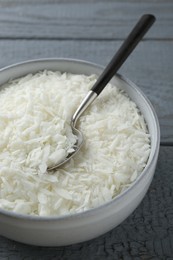 Photo of Soy wax in bowl on grey wooden table