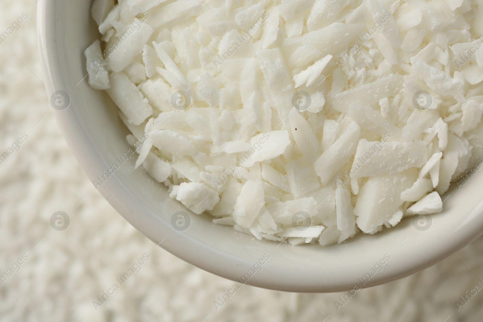 Photo of Soy wax in bowl on pile, top view