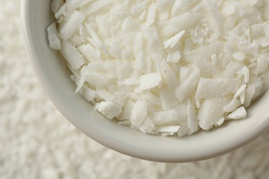 Photo of Soy wax in bowl on pile, top view