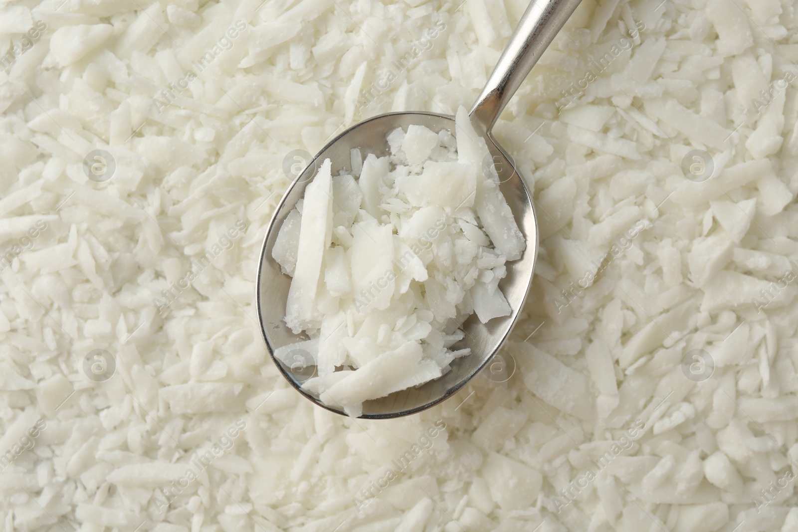 Photo of Soy wax in spoon on pile, top view