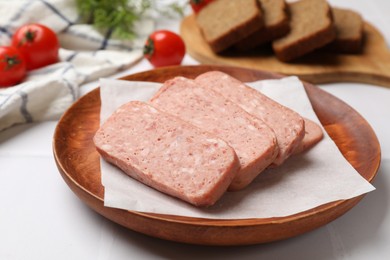 Photo of Canned meat on white tiled table, closeup