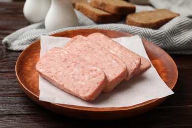 Photo of Canned meat and bread on wooden table, closeup