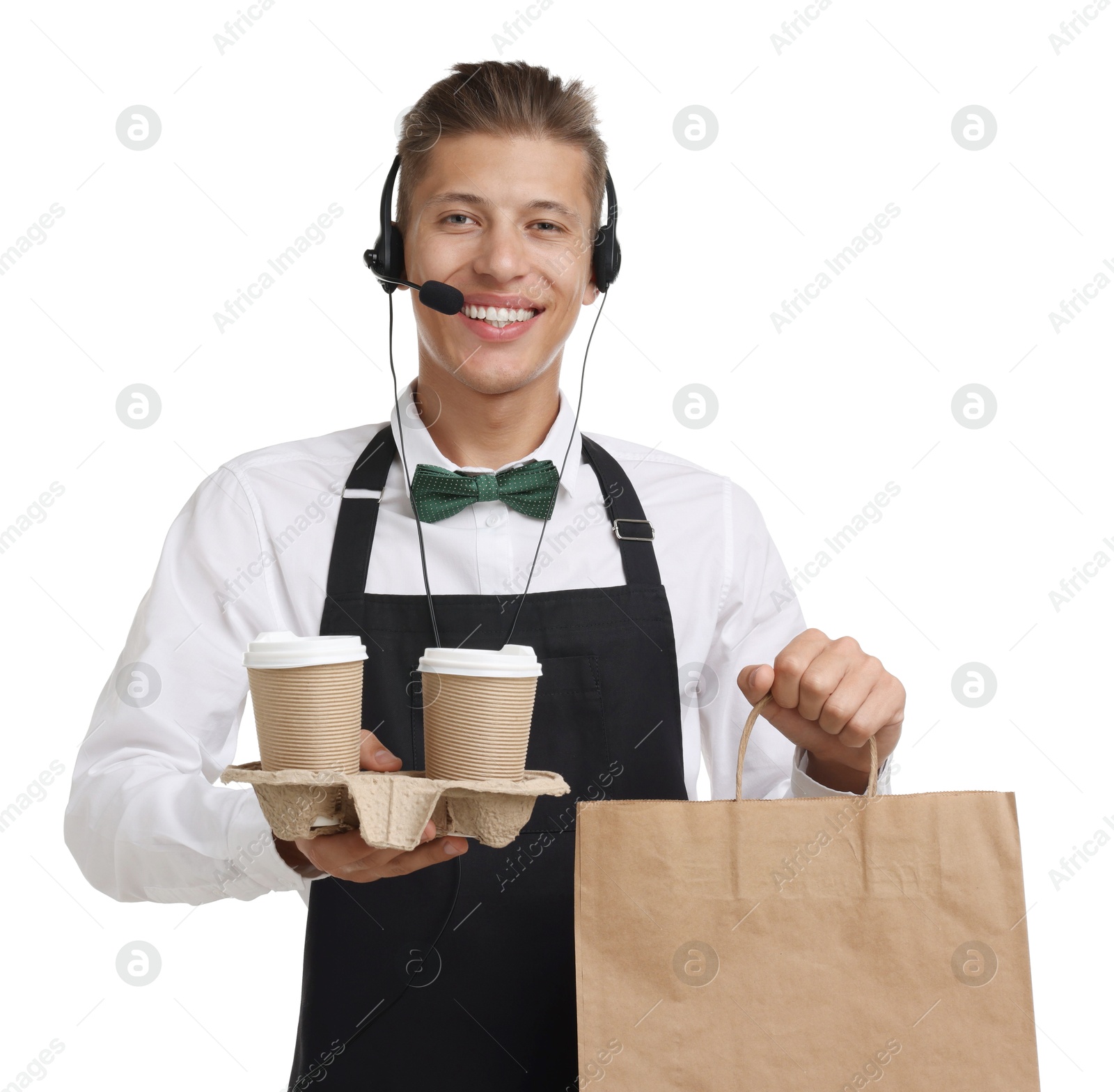 Photo of Fast-food worker with paper bag and cups on white background