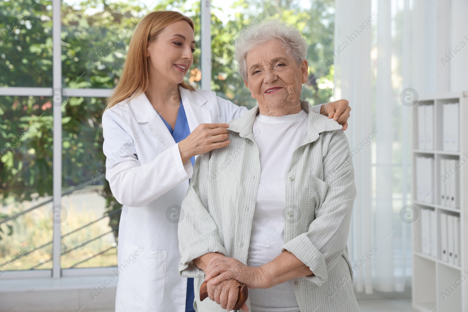 Photo of Healthcare worker supporting senior patient in hospital