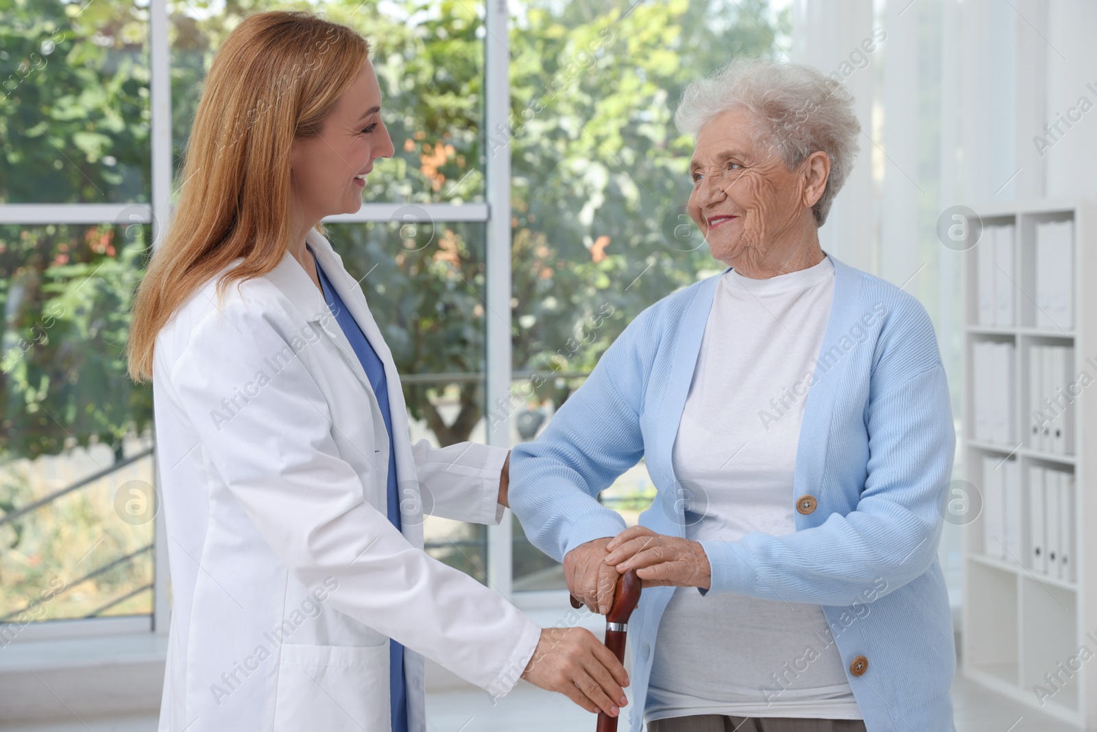 Photo of Healthcare worker supporting senior patient in hospital