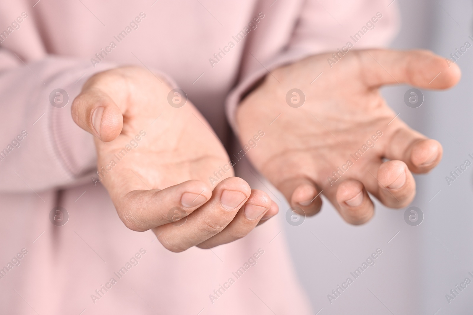 Photo of Man holding something on light background, closeup