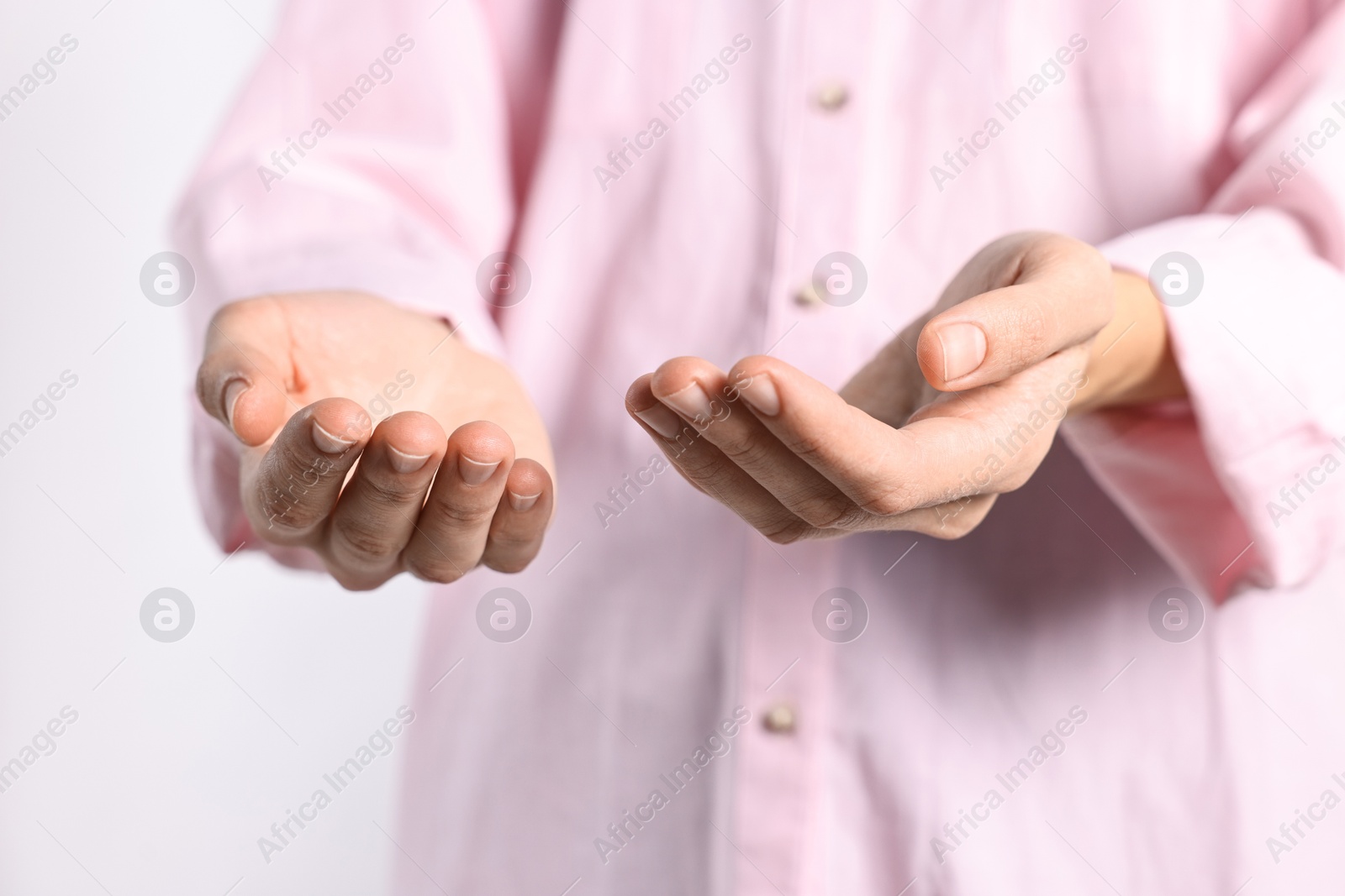 Photo of Man holding something on light background, closeup