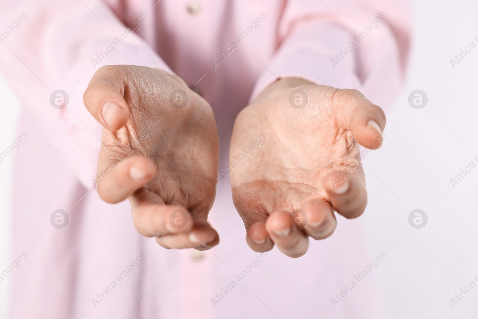 Photo of Man holding something on light background, closeup