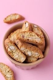 Photo of Tasty almond biscuits (Cantuccini) on pink background, above view