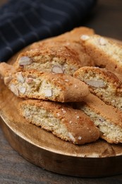 Photo of Tasty almond biscuits (Cantuccini) on wooden table, closeup