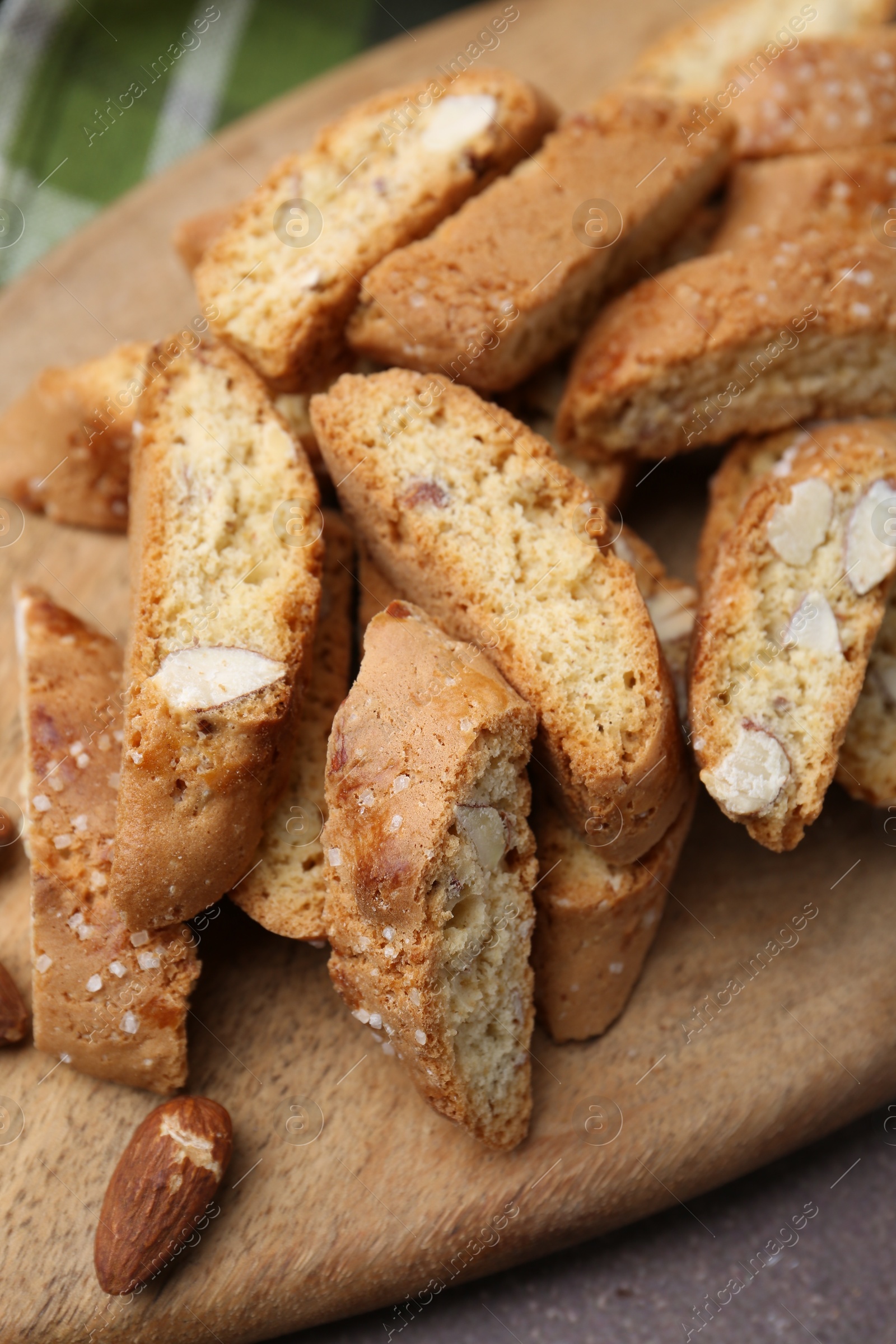 Photo of Tasty almond biscuits (Cantuccini) and nuts on brown table, above view